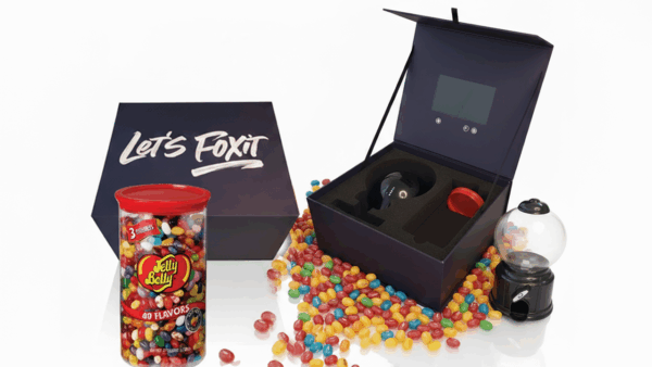 FOX IT custom video box with built-in HD screen, branded Jelly Belly jar, and dispenser used for tech sales prospecting.